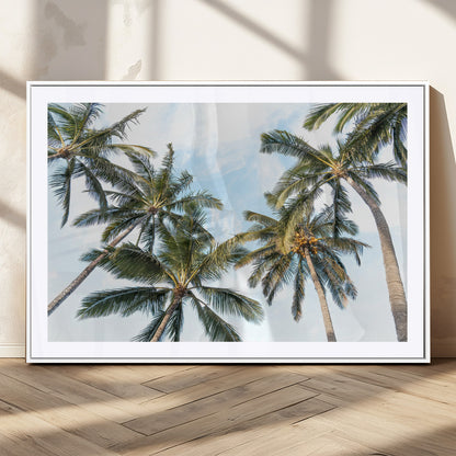 Framed canvas of tall palm trees reaching into a tropical sky, ideal for beach home or relaxed island-inspired wall decor.