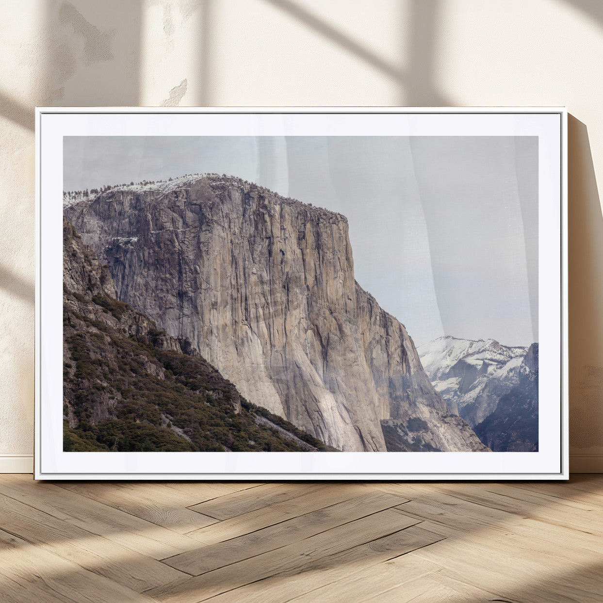 Framed canvas of El Capitan’s vertical granite face in Yosemite with snowy peaks, ideal for Sierra minimalism or mountain-inspired decor.