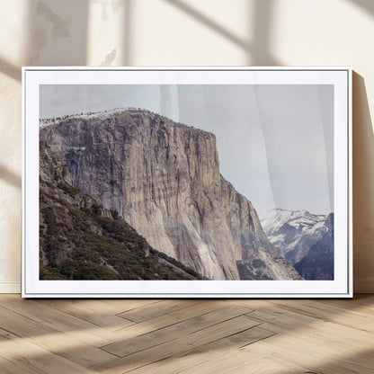 Framed canvas of El Capitan’s vertical granite face in Yosemite with snowy peaks, ideal for Sierra minimalism or mountain-inspired decor.