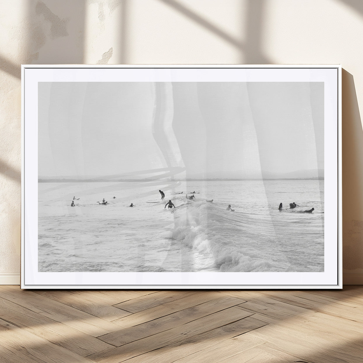 Monochrome photo of surfers riding and waiting on ocean waves, ideal for surf-themed or coastal energy wall decor.
