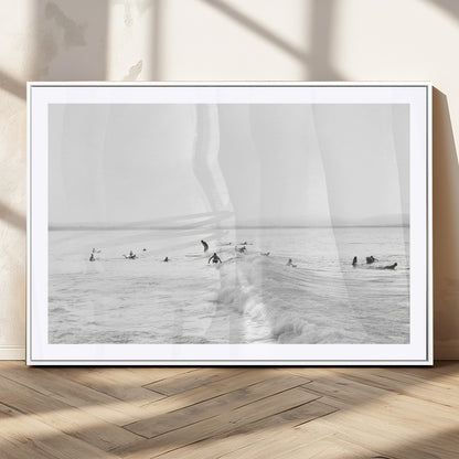 Monochrome photo of surfers riding and waiting on ocean waves, ideal for surf-themed or coastal energy wall decor.