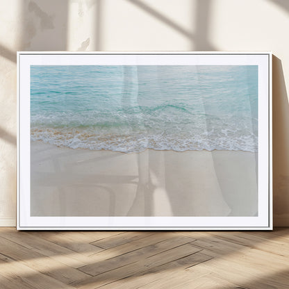 Soft shoreline with gentle aqua waves on smooth sand, ideal for minimalist coastal or pastel ocean-inspired home wall decor.