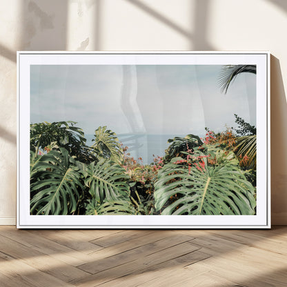 Monstera leaves and tropical flowers framing a calm ocean view, ideal for tropical coastal or exotic jungle-style interior wall decor.