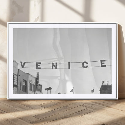 Black and white photo of Venice Beach sign and palm-lined street, perfect for urban coastal or minimalist LA-inspired wall decoration.