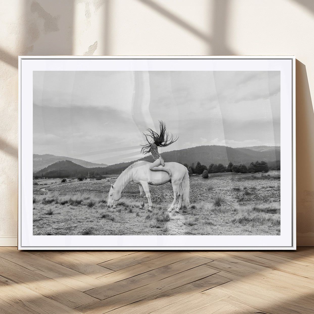 Black and white photo of a woman on a white horse in moody tones, ideal for Western Boho or modern rustic-style home decor.