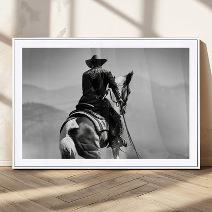 Black and white canvas of a cowboy on horseback with moody tones, perfect for rustic western or country-inspired home decor.