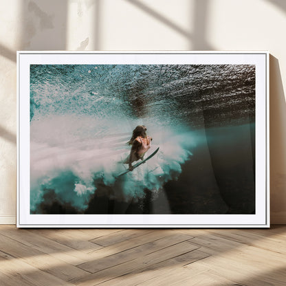 Vibrant underwater photo of a female surfer diving through turquoise waves, perfect for coastal boho or surf-inspired home decor.