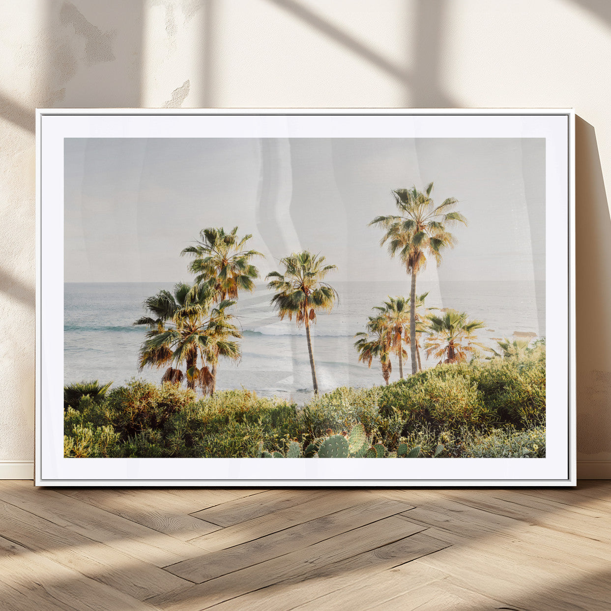 Framed print of sunlit palm trees on the California coast with warm tones, perfect for coastal minimalist or beach-style home decor.