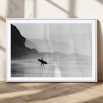 A lone surfer walking along a misty beach with cliffs in the background, carrying their board, capturing a serene and minimal ocean moment.