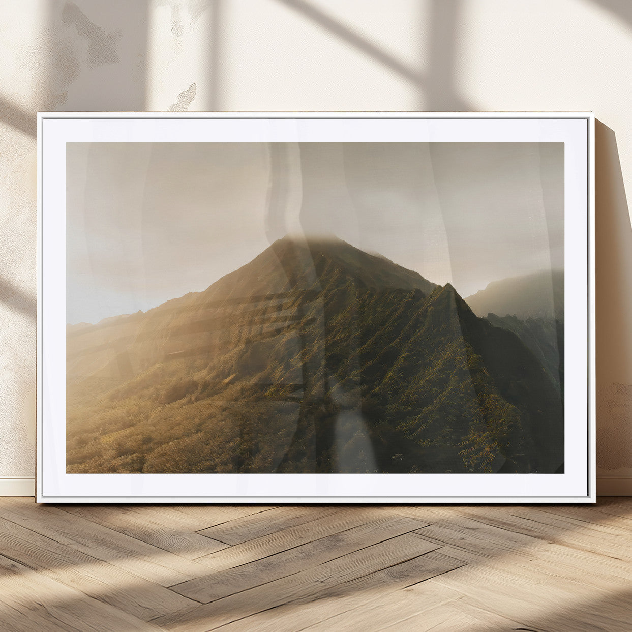 Sunlit mountain peak with mist rolling over its rugged slopes, bathed in golden light, creating a warm and tranquil nature-inspired scene.