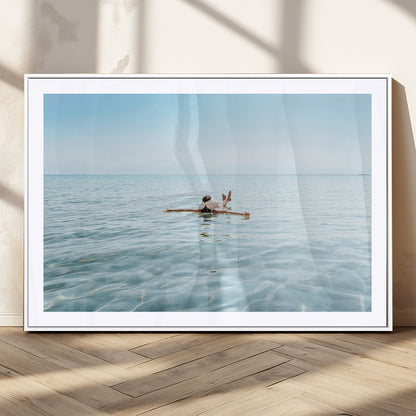A peaceful minimalist scene of a person floating on crystal-clear water, surrounded by a vast open horizon, capturing relaxation and serenity in a tranquil aquatic setting.