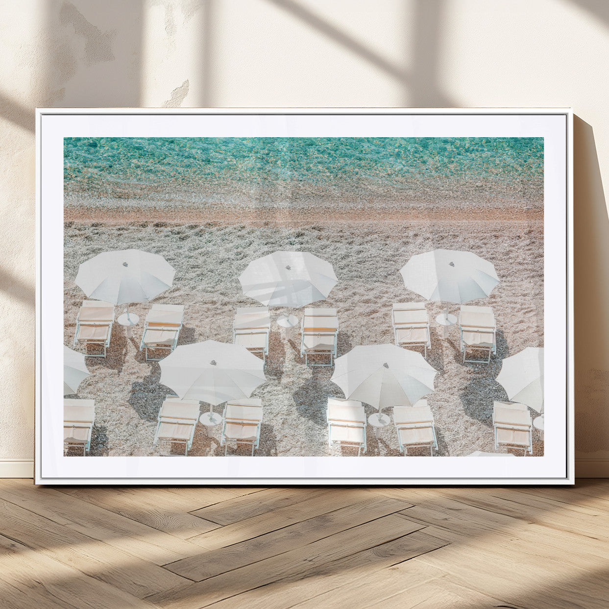 A bright beach scene with white umbrellas, pastel sand, and turquoise waters, creating a tranquil coastal vibe, perfect for beach house or summer decor.