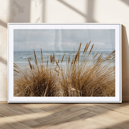 Canvas of golden beach grass swaying by the ocean under a soft cloudy sky, perfect for neutral-toned or coastal minimalist decor.