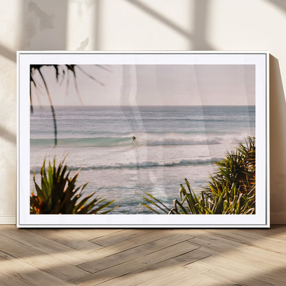 Canvas of a lone surfer riding a pastel wave at sunrise, perfect for tropical or coastal-themed spaces with a relaxed, airy vibe.