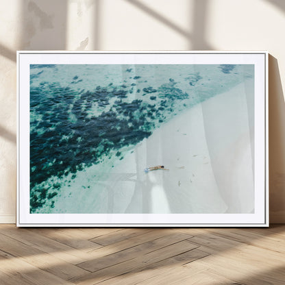 Canvas featuring an aerial view of a swimmer in shallow turquoise waters with coral patterns, ideal for tropical coastal home decor.