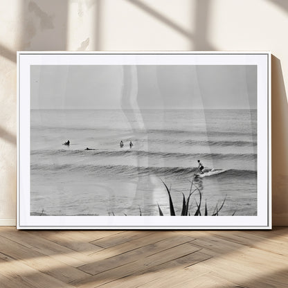 Monochrome canvas of surfers on calm ocean waves, ideal for minimalist coastal or beach-inspired interior decor.