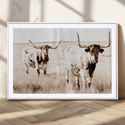 Two Texas longhorn cows standing in a sepia-toned pasture, evoking rustic charm perfect for farmhouse or western country interiors. (