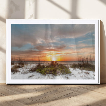 A tranquil beach scene featuring golden sunset hues over the water, with grasses in the foreground and a peaceful, serene atmosphere.