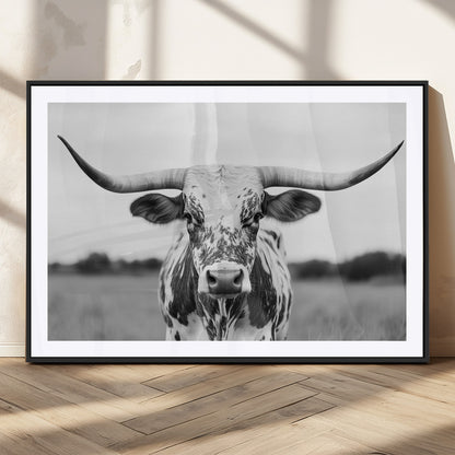 Capture the strength and elegance of nature with this striking black and white portrait of a longhorn cow. Its powerful presence makes a bold statement in any room.