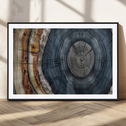 A stunning close-up of a tree trunk showing the intricate, circular growth rings, showcasing the natural textures and rich contrasts in deep blues, browns, and silvers.