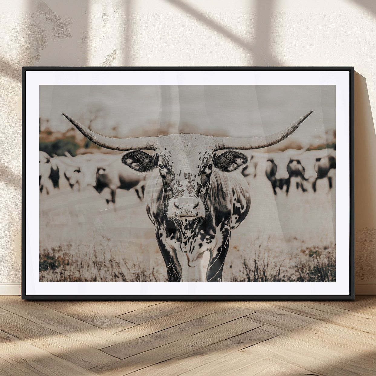Canvas of a speckled Texas longhorn standing boldly in a field with a herd behind, perfect for rustic western or farmhouse wall decor.