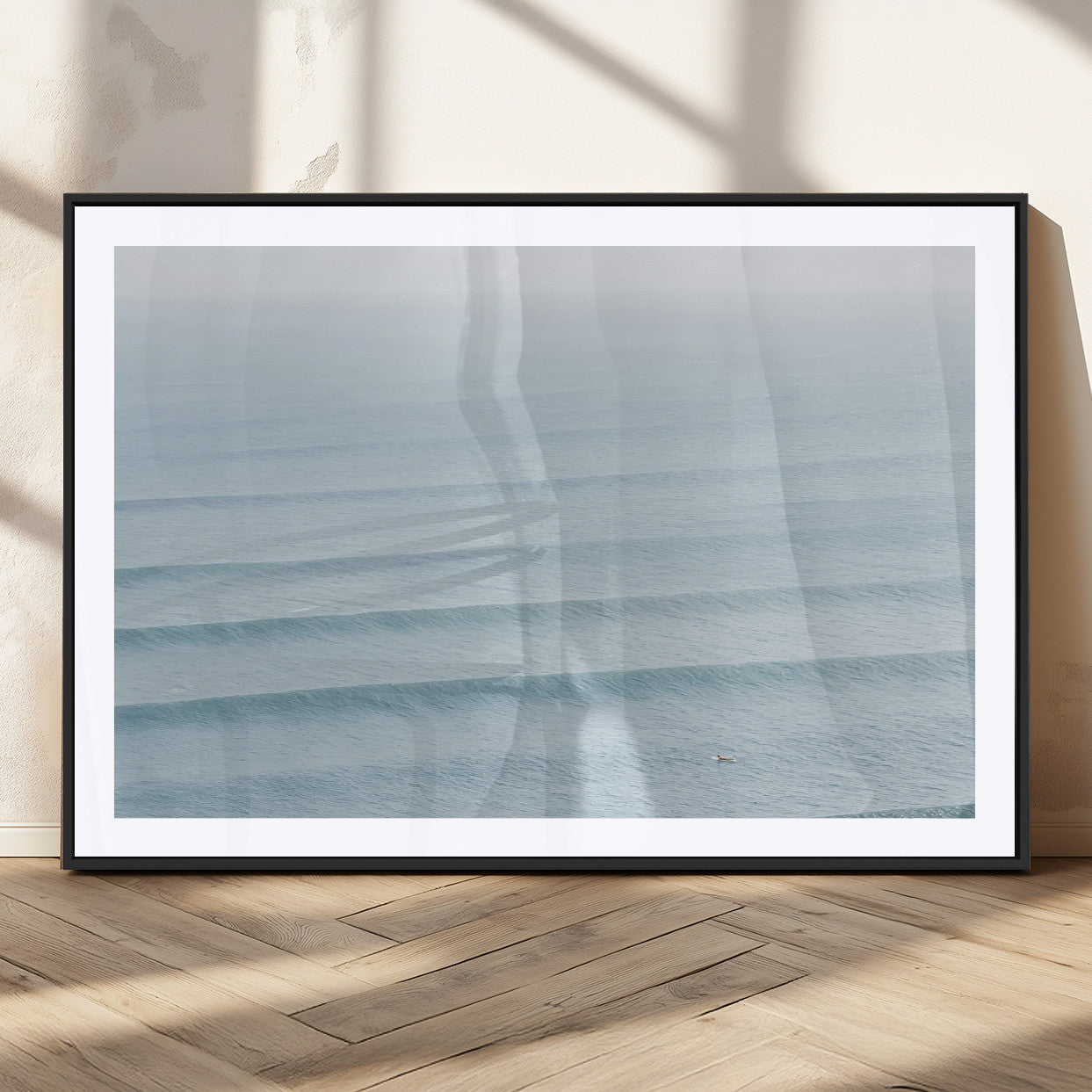 Framed canvas of repeating ocean waves with a distant solo surfer, ideal for minimalist ocean or calm coastal wall decor.