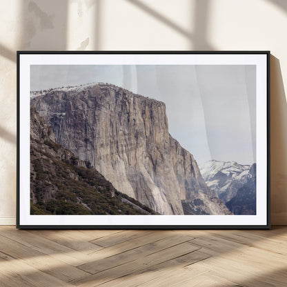 Framed canvas of El Capitan’s vertical granite face in Yosemite with snowy peaks, ideal for Sierra minimalism or mountain-inspired decor.
