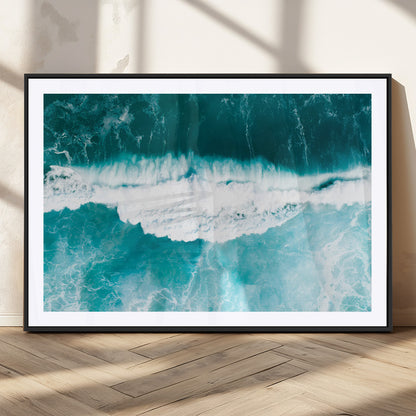Aerial view of turquoise ocean waves crashing with white foam, perfect for tropical coastal or modern beach-style home decor.