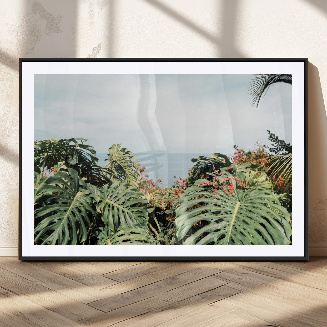 Monstera leaves and tropical flowers framing a calm ocean view, ideal for tropical coastal or exotic jungle-style interior wall decor.