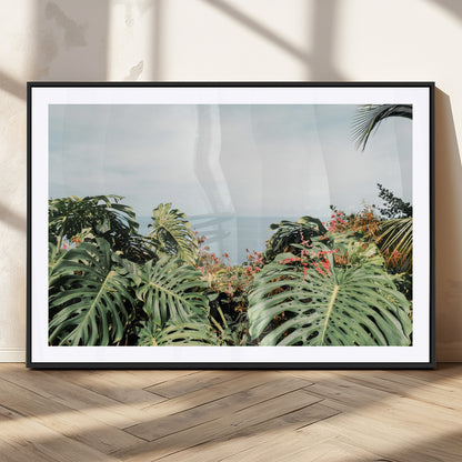 Monstera leaves and tropical flowers framing a calm ocean view, ideal for tropical coastal or exotic jungle-style interior wall decor.