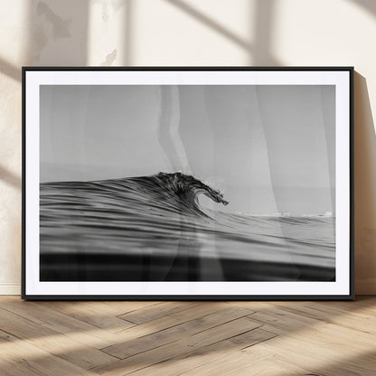 Striking black and white photo of a curling wave, ideal for modern coastal or minimalist wall decor settings.