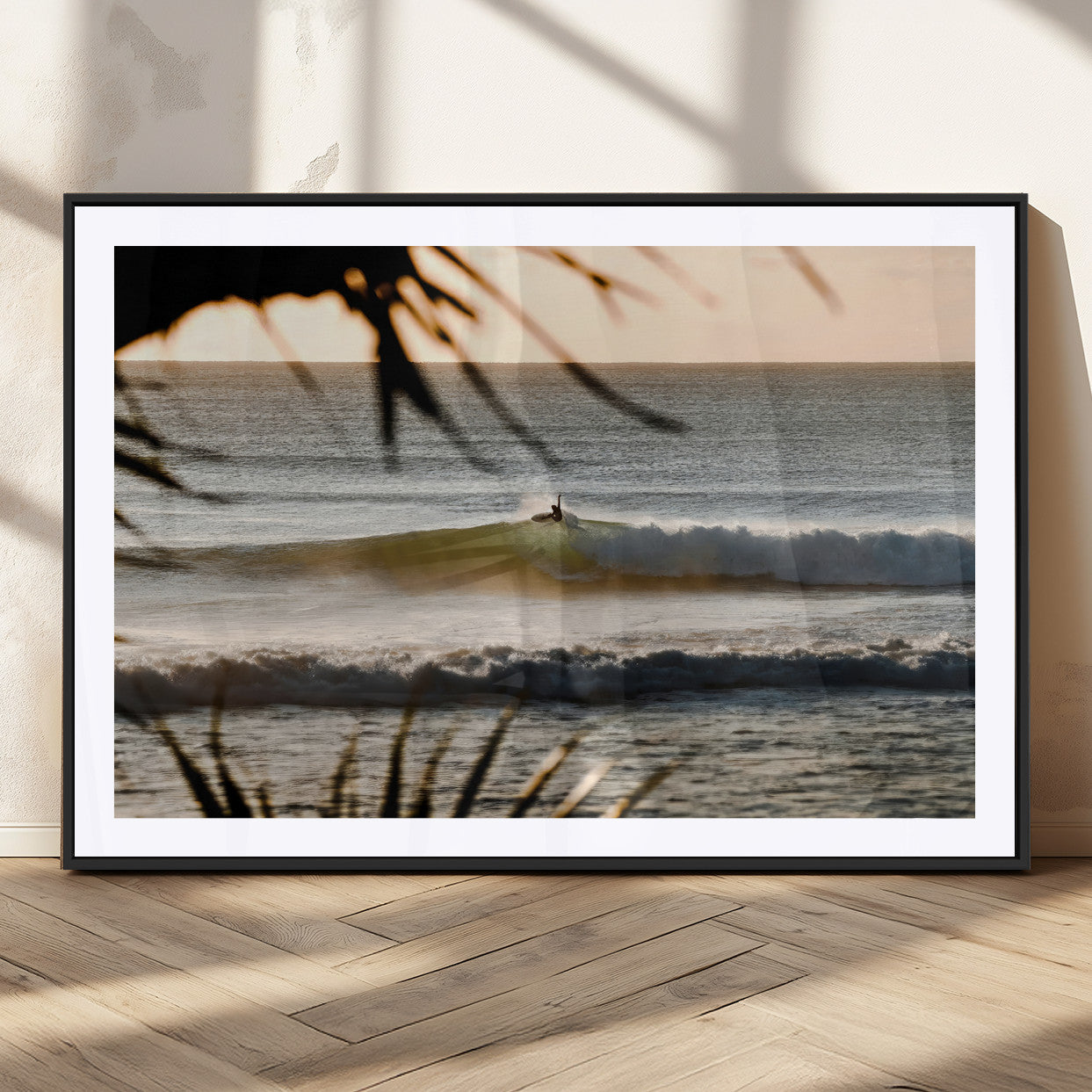 Photo of a surfer riding a golden hour wave at sunset, with tropical tones and dreamy light, perfect for tropical boho or coastal home decor.