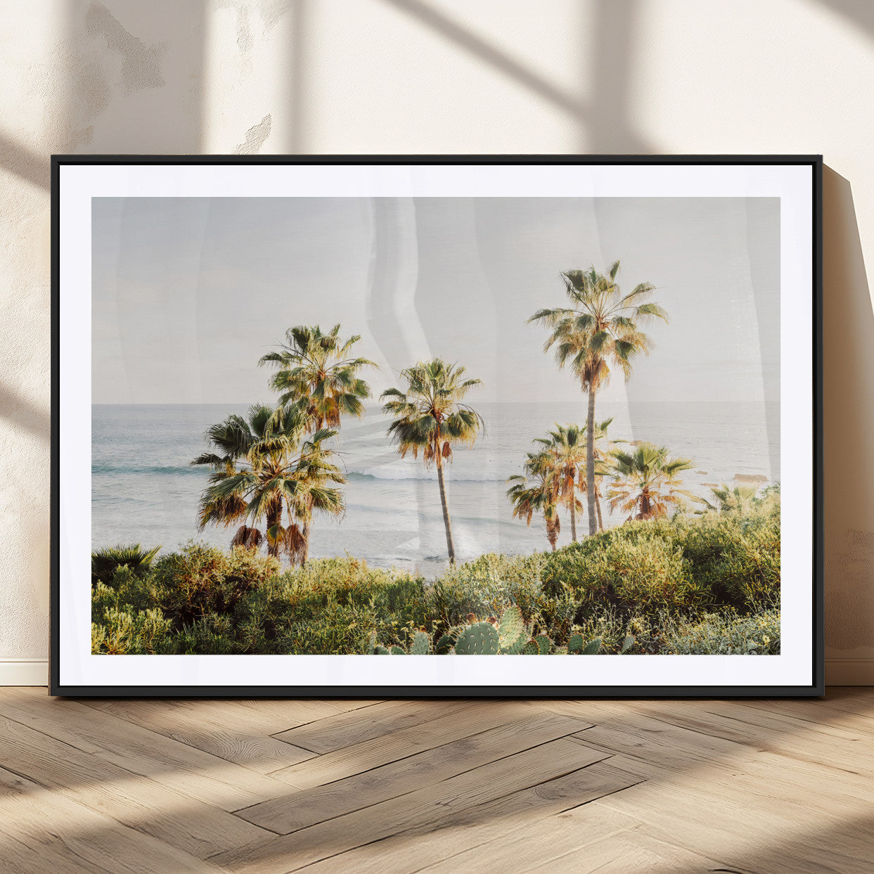 Framed print of sunlit palm trees on the California coast with warm tones, perfect for coastal minimalist or beach-style home decor.