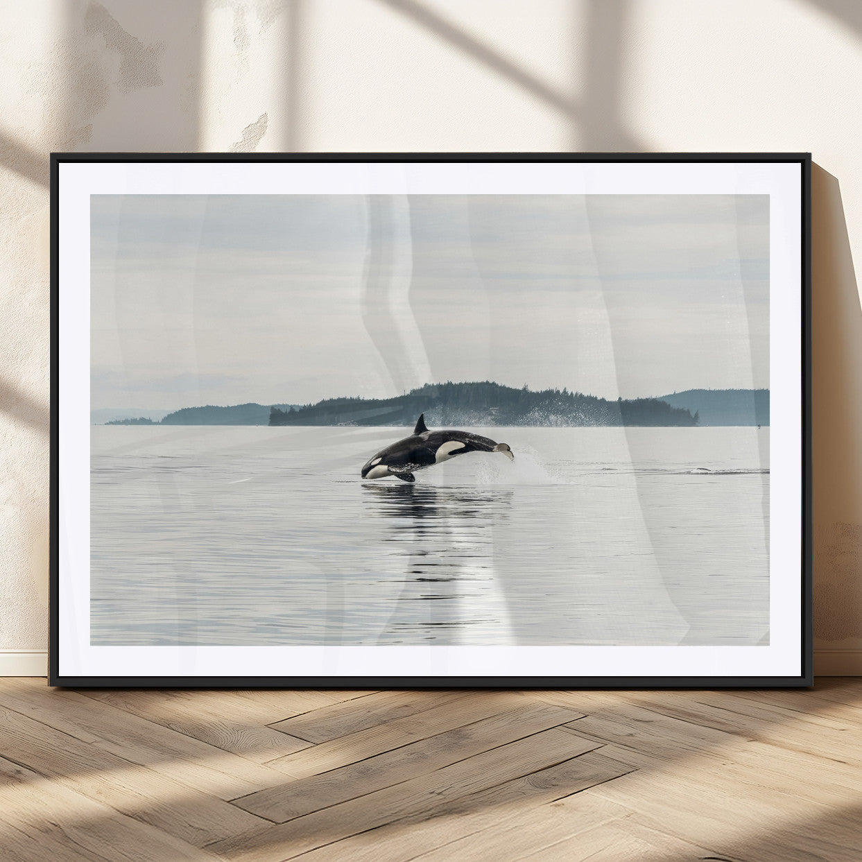 An orca jumping out of calm ocean waters with a misty island in the background, creating a serene and minimalist marine wildlife scene.