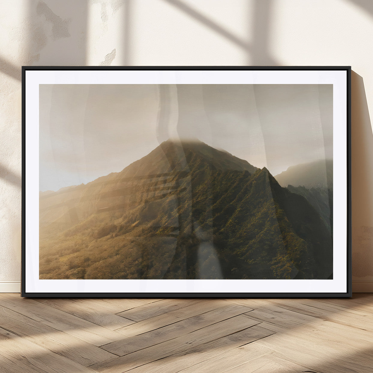 Sunlit mountain peak with mist rolling over its rugged slopes, bathed in golden light, creating a warm and tranquil nature-inspired scene.