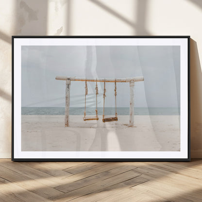A rustic wooden beach swing stands on a serene sandy shore with an ocean horizon in the background, creating a tranquil and dreamy coastal escape.
