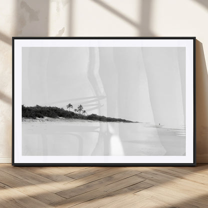 A black and white minimalist coastal scene with a vast open beach, distant palm trees, and a lone figure walking along the shoreline, evoking serenity and solitude.