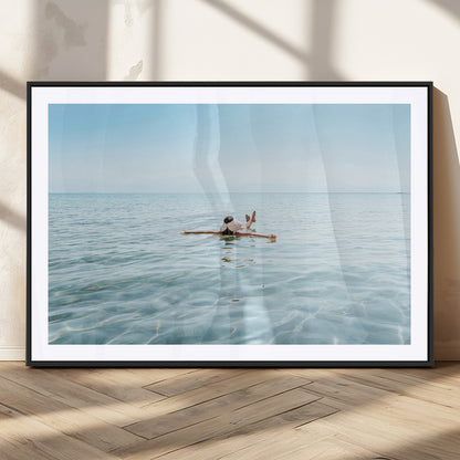 A peaceful minimalist scene of a person floating on crystal-clear water, surrounded by a vast open horizon, capturing relaxation and serenity in a tranquil aquatic setting.
