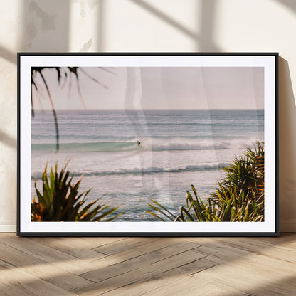 Canvas of a lone surfer riding a pastel wave at sunrise, perfect for tropical or coastal-themed spaces with a relaxed, airy vibe.