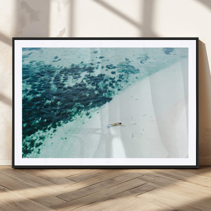 Canvas featuring an aerial view of a swimmer in shallow turquoise waters with coral patterns, ideal for tropical coastal home decor.