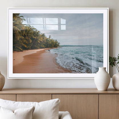 Framed canvas of a tropical beach with palm trees and soft waves, ideal for coastal escape or serene nature-inspired home decor.