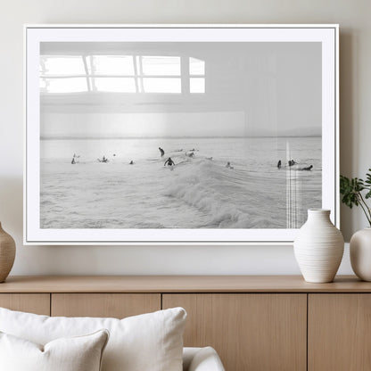 Monochrome photo of surfers riding and waiting on ocean waves, ideal for surf-themed or coastal energy wall decor.