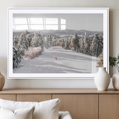 Bright ski trail lined with snow-covered pines and a skier in orange, perfect for alpine adventure or winter sports-inspired decor.