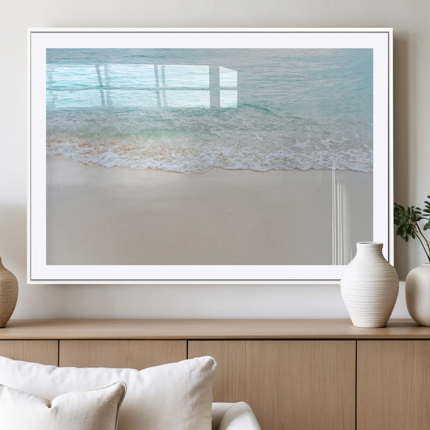 Soft shoreline with gentle aqua waves on smooth sand, ideal for minimalist coastal or pastel ocean-inspired home wall decor.