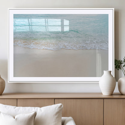 Soft shoreline with gentle aqua waves on smooth sand, ideal for minimalist coastal or pastel ocean-inspired home wall decor.