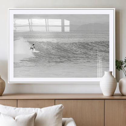 Monochrome photo of a surfer riding a wave with distant mountains, ideal for coastal motion or black and white surf-themed wall decor.