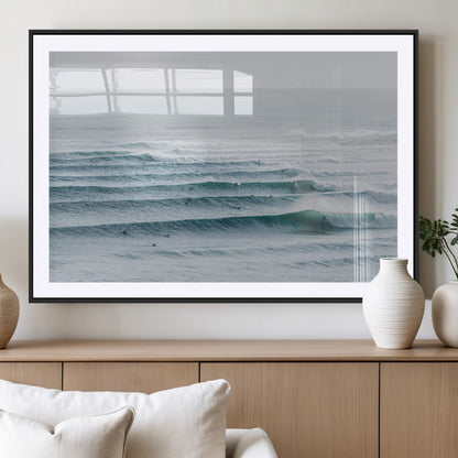 High-angle view of surfers lining up across layered ocean waves, ideal for minimal coastal or surf-inspired room decor.