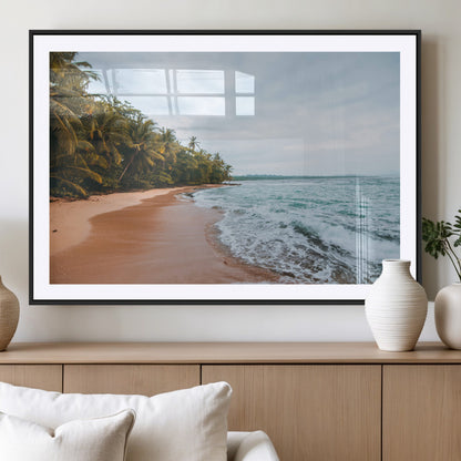 Framed canvas of a tropical beach with palm trees and soft waves, ideal for coastal escape or serene nature-inspired home decor.