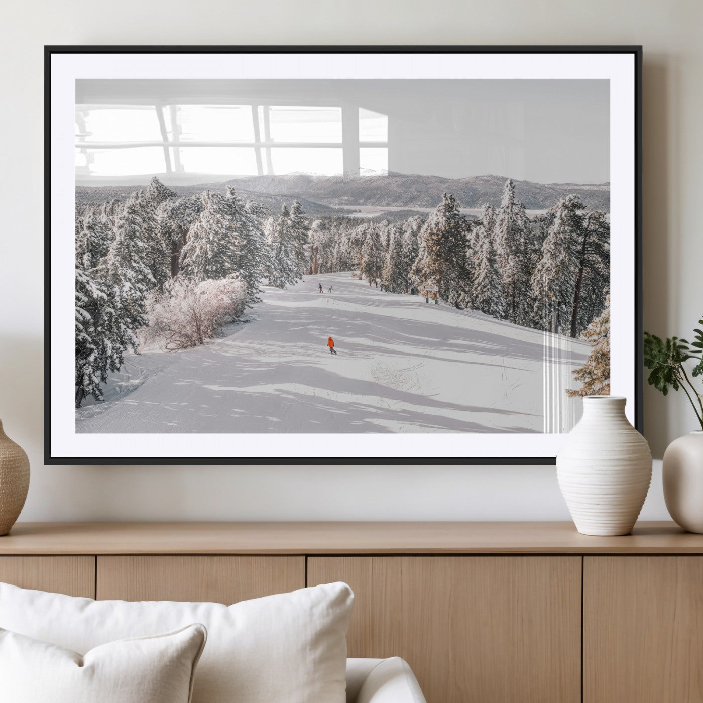 Bright ski trail lined with snow-covered pines and a skier in orange, perfect for alpine adventure or winter sports-inspired decor.