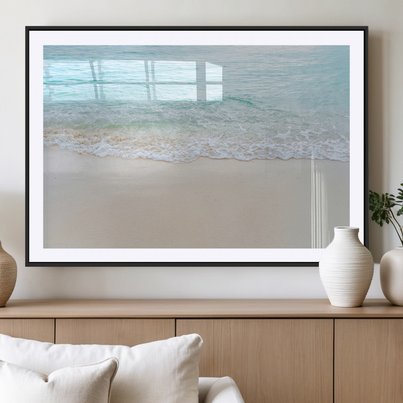 Soft shoreline with gentle aqua waves on smooth sand, ideal for minimalist coastal or pastel ocean-inspired home wall decor.
